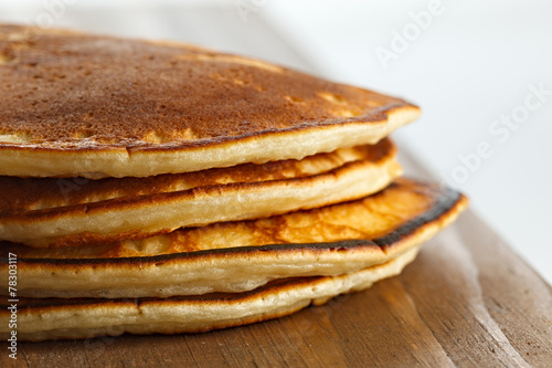 Fried pancakes on a wooden surface.