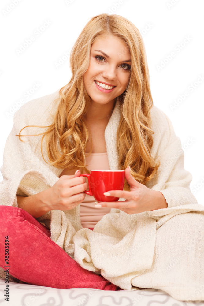 Young woman relaxing in bed with a cup of coffee Young woman relaxing in bed with a cup of coffee
