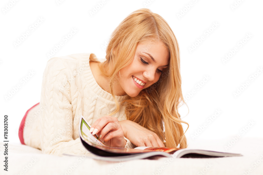 Young beautiful woman reading a magazine Young beautiful woman reading a magazine