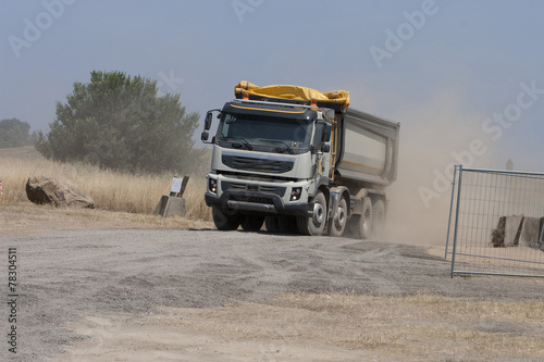 Truck and bulldozer work in the quarry