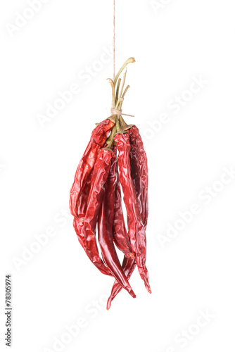 Hanged dry and sear hot red chili peppers isolated on white background photo