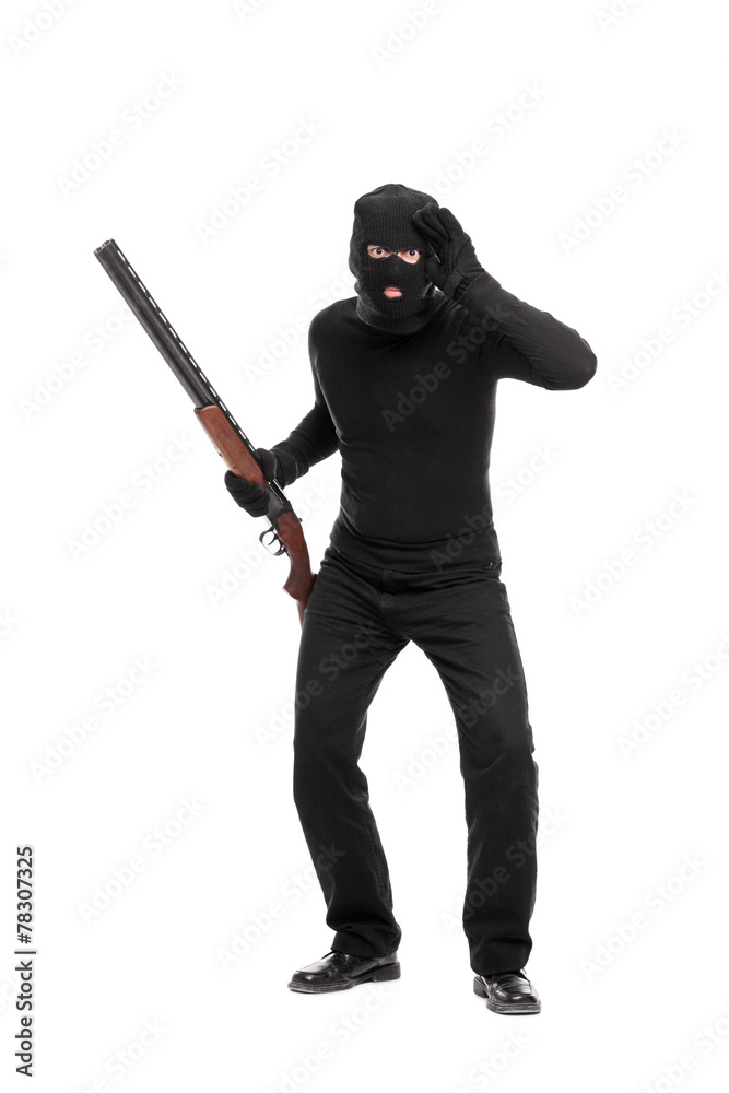 Burglar with rifle looking through an imaginary glass Burglar with rifle looking through an imaginary glass