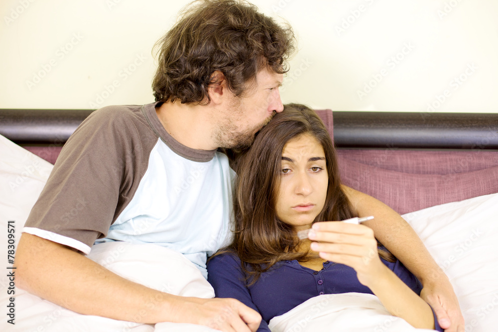Man kissing sad ill woman with fever Man kissing sad ill woman with fever