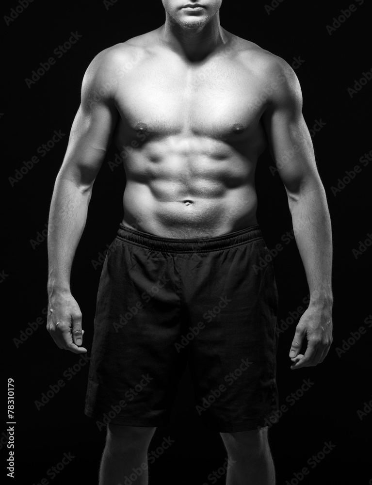 Strong body with naked torso and black shorts in black-and-white Strong body with naked torso and black shorts in black-and-white
