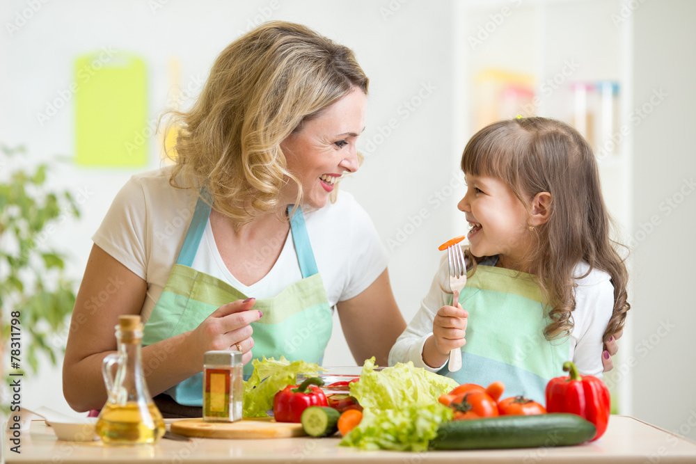 mother and her kid preparing healthy food and having fun