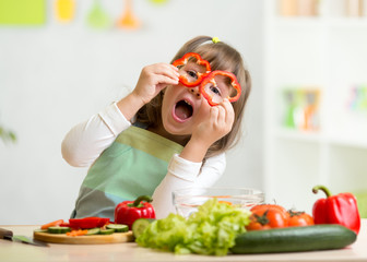 kid girl having fun with food vegetables
