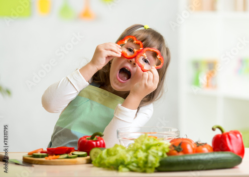 kid girl having fun with food vegetables