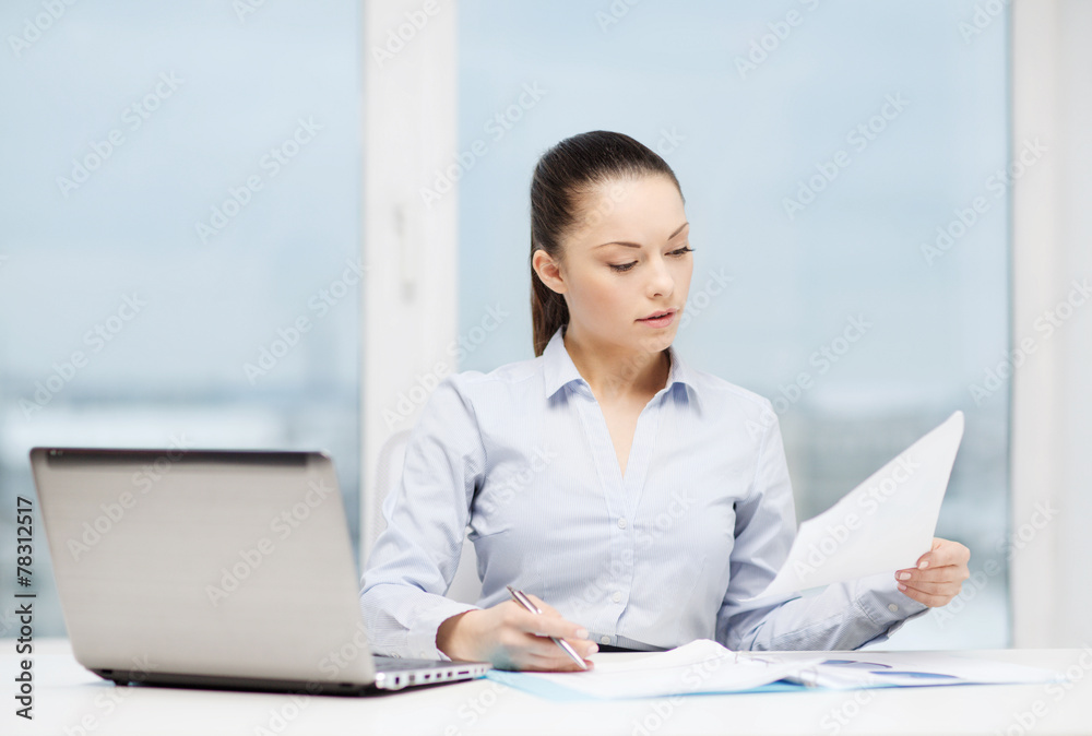 businesswoman with laptop and charts in office businesswoman with laptop and charts in office