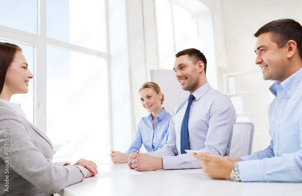 group of smiling businesspeople meeting in office group of smiling businesspeople meeting in office