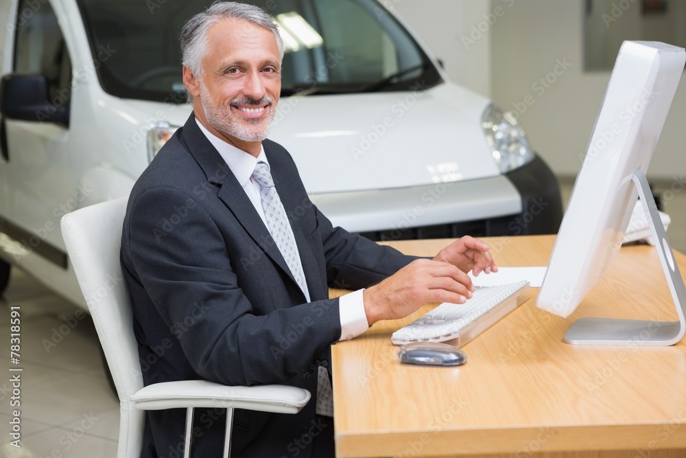 Cheerful businessman working at his desk Cheerful businessman working at his desk