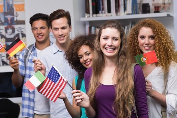 Happy students waving international flags