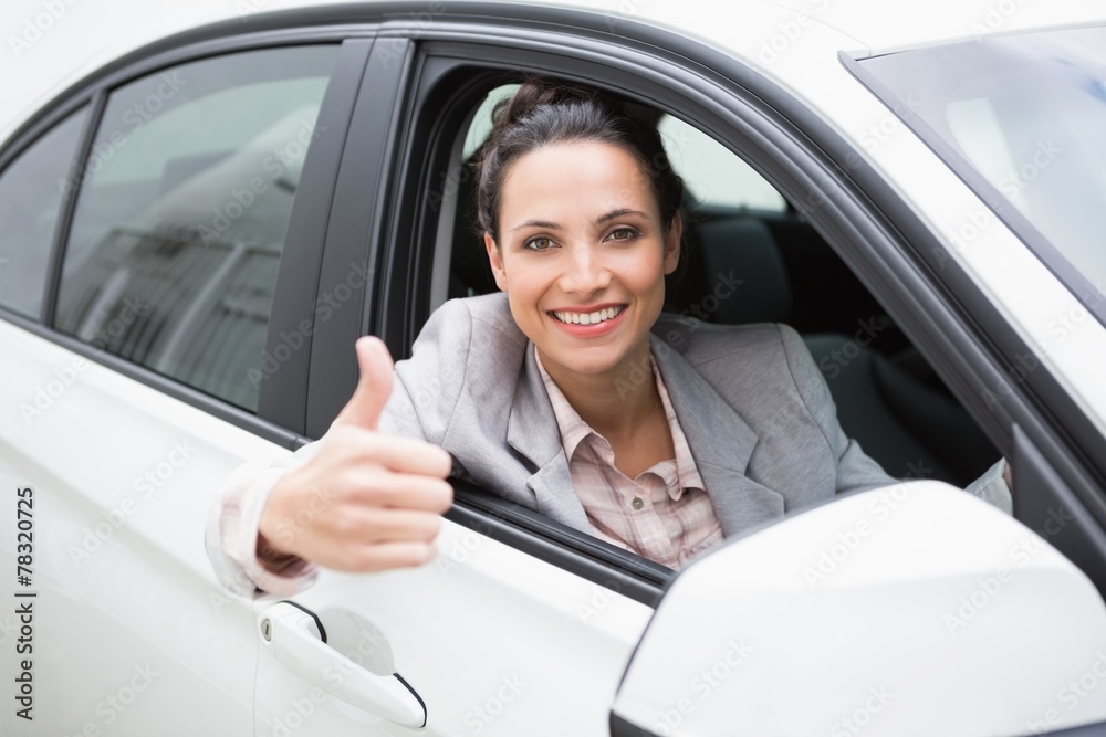 Smiling businesswoman giving thumbs up