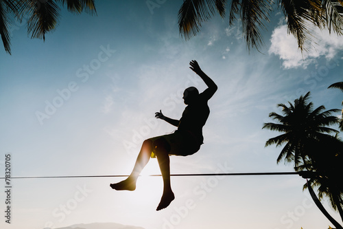 teenage jumping on slackline