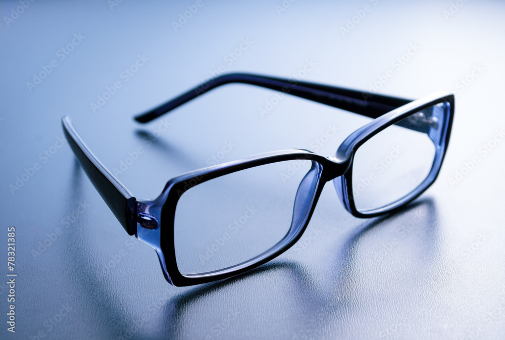Horn-rimmed glasses on blue background