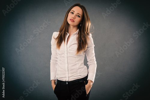 Elegant woman portrait isolated against grey grunge background.