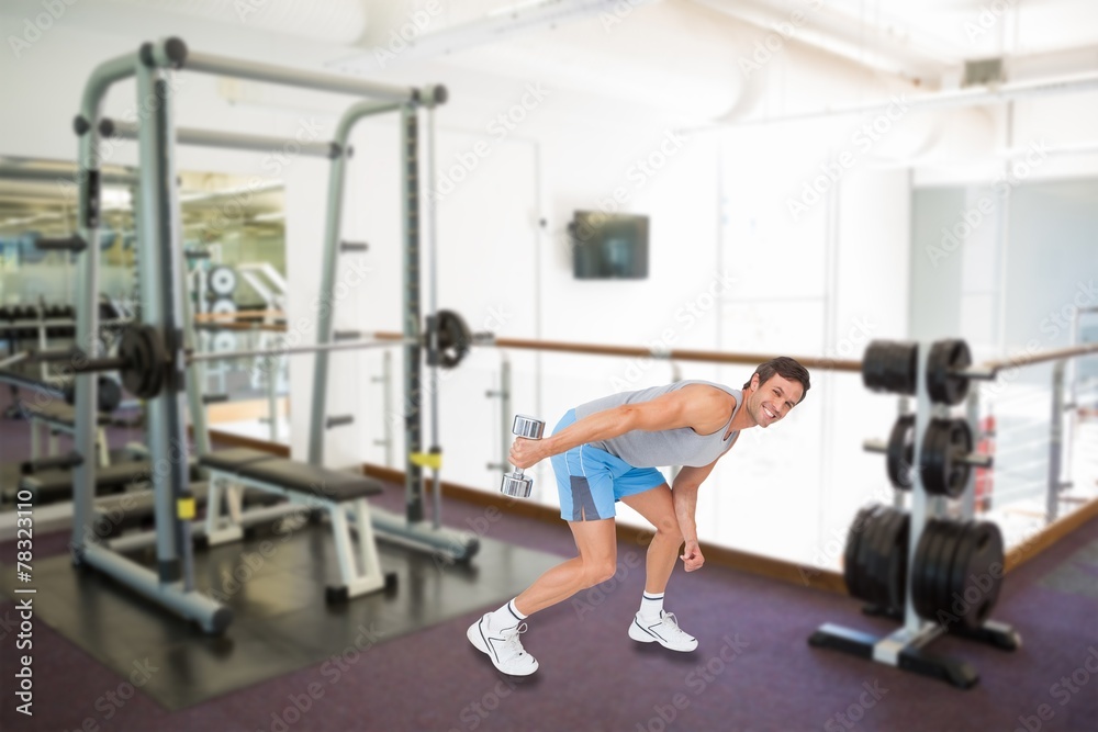 Smiling fit young man exercising with dumbbel Smiling fit young man exercising with dumbbel