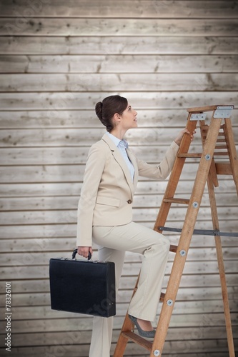 Businesswoman climbing career ladder with briefcase