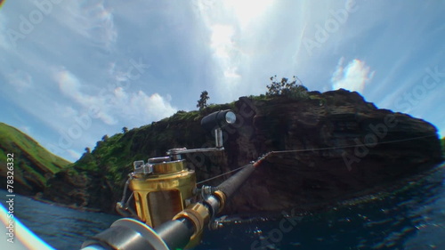 Fishing rod and reel at work..on a boat in the sea; shaking boat