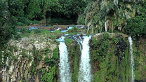 High scenic waterfalls from a rocky stream; wild tropical nature