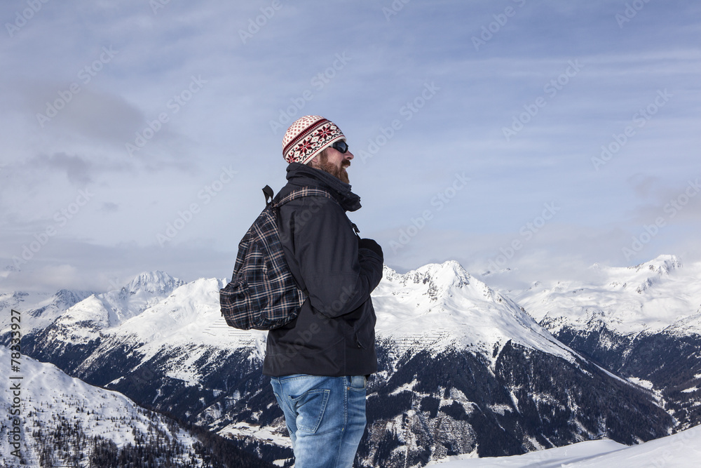 Young man enjoys the view in the mountains