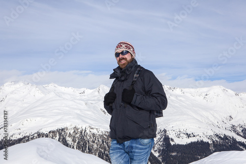 Young man enjoys the view in the mountains