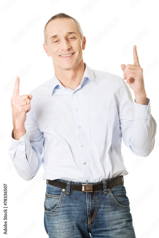 Happy handsome man pointing up Happy handsome man pointing up