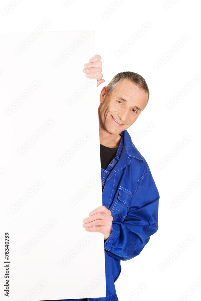 Happy worker presenting empty banner Happy worker presenting empty banner