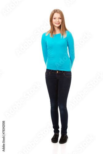 Young woman standing with toothy smile