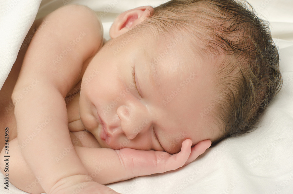 New born baby boy sleeping taking a nap in white sheets. New born baby boy sleeping taking a nap in white sheets.