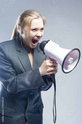 Furious Caucasian Blond Female in Suite Shouting Using Megaphone