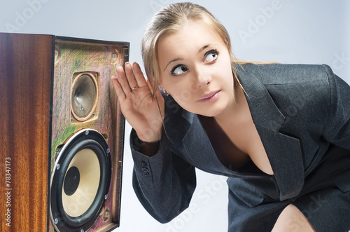 Surprised Caucasian Blond Female Harkens to Outdated Loudspeaker photo