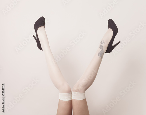 Female legs up in the air wearing stockings and posing