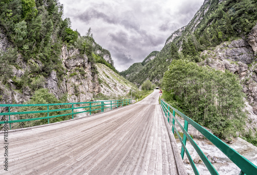 Wooden bridge through the Alps photo