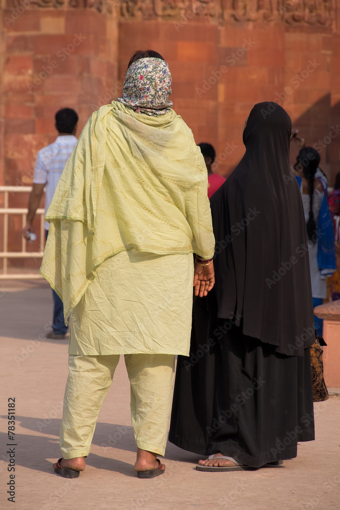 Indian women standing at Qutub Minar, Delhi, India