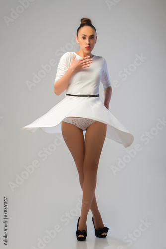Pretty woman in white dress dancing