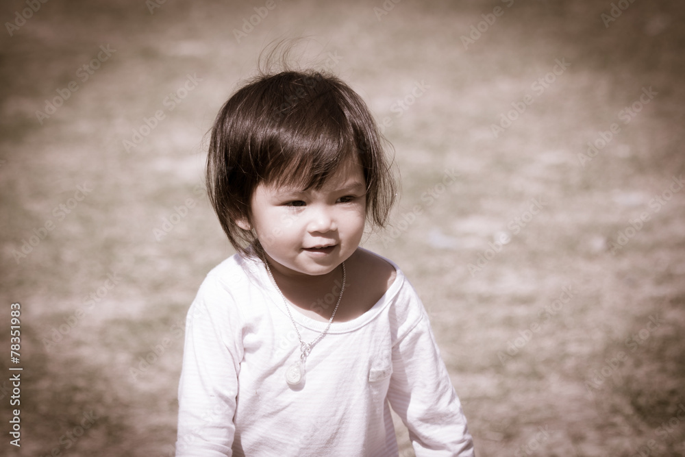 Cute little girl is playing in the garden in vintage style Cute little girl is playing in the garden in vintage style