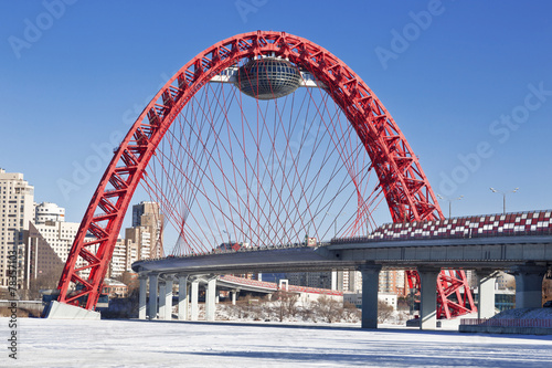 Red bridge over the frozen Moskva river, Moscow, Russia