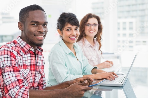 Smiling teamwork using laptop and tablet