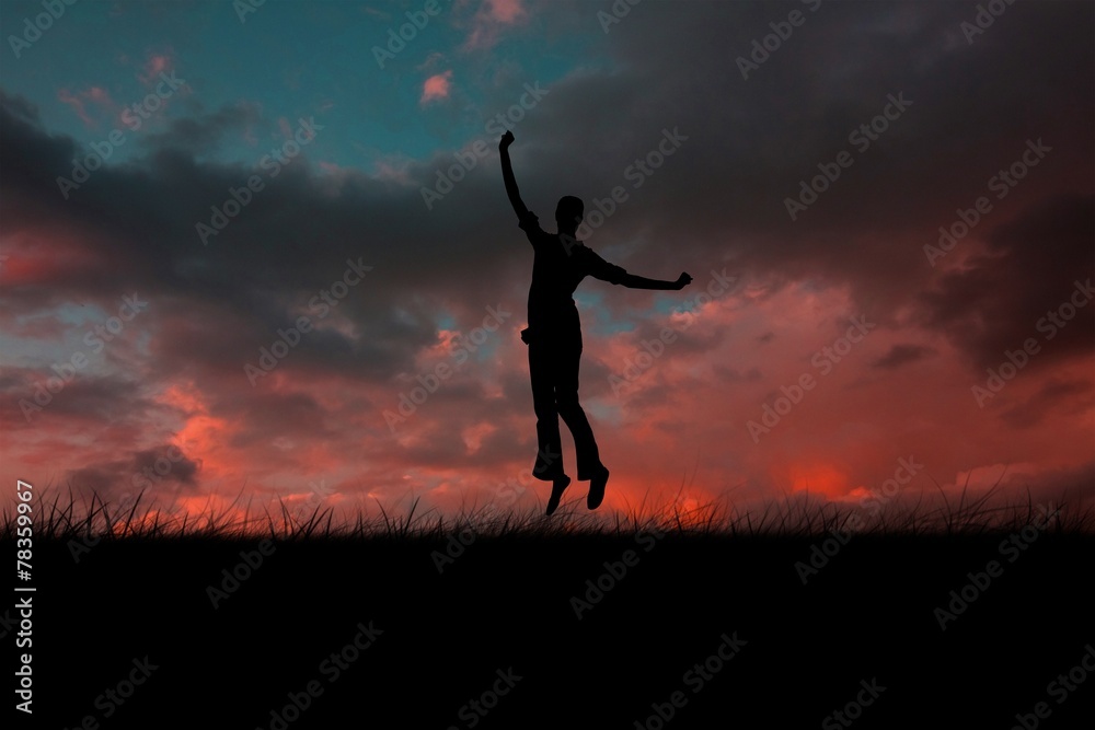 Composite image of silhouette of jumping woman