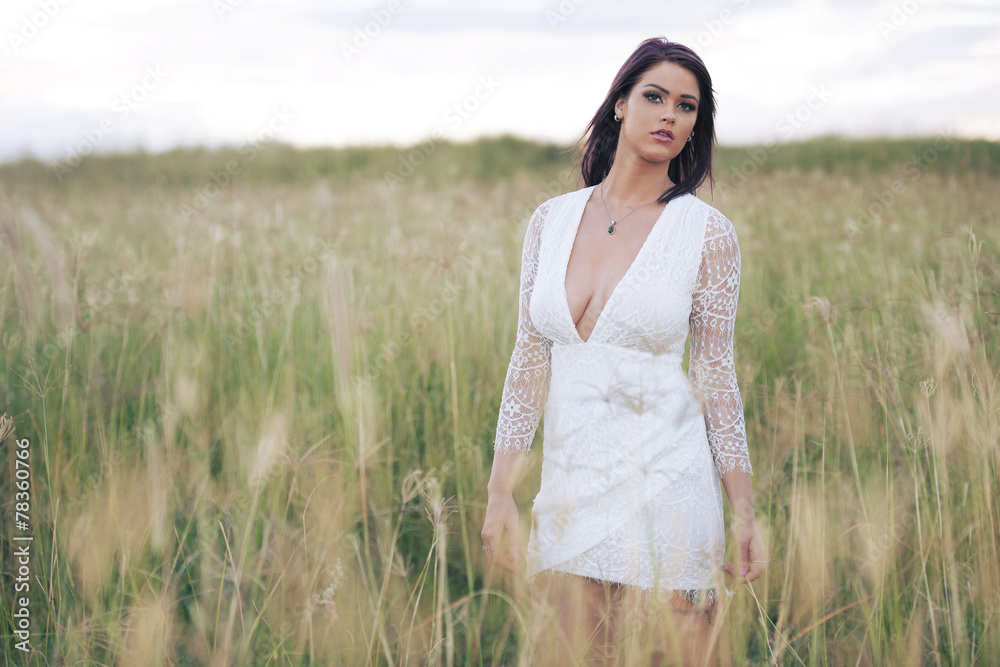 Woman in a field in the later afternoon posing Woman in a field in the later afternoon posing