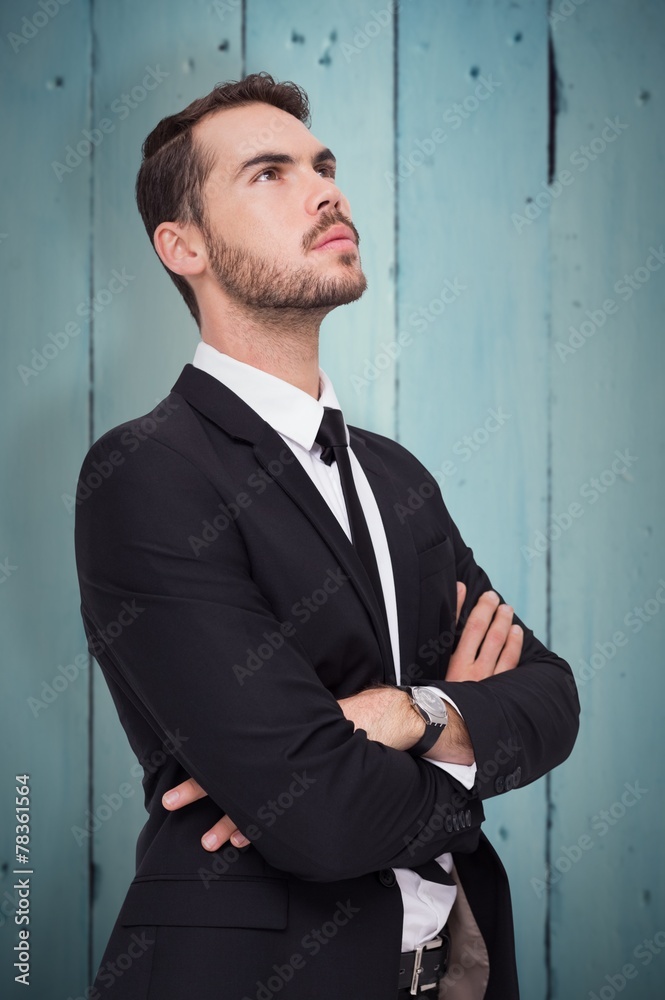 Composite image of thinking businessman with his arms crossed Composite image of thinking businessman with his arms crossed