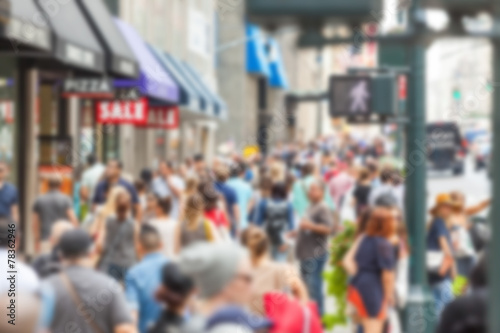 Crowded sidewalk on 5th Avenue with tourists. Blurred Background