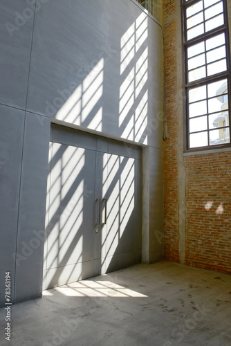 Sunlight from window on the cement walls and floor