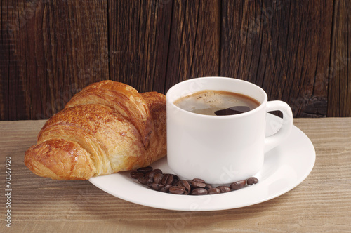 Coffee cup and croissant