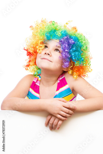 Girl in clown is holding blank banner