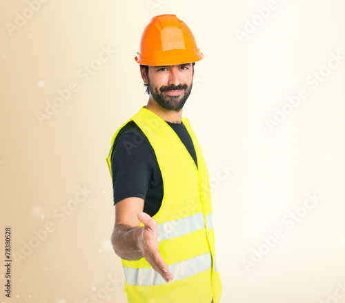 Workman making a deal over isolated white background