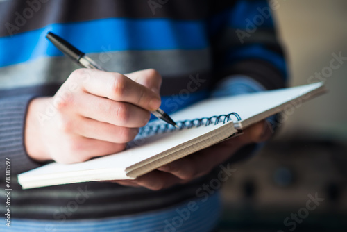 man holding a clipboard and write on it