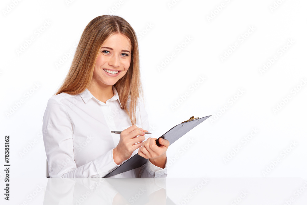 Business young woman writes on the folder Business young woman writes on the folder