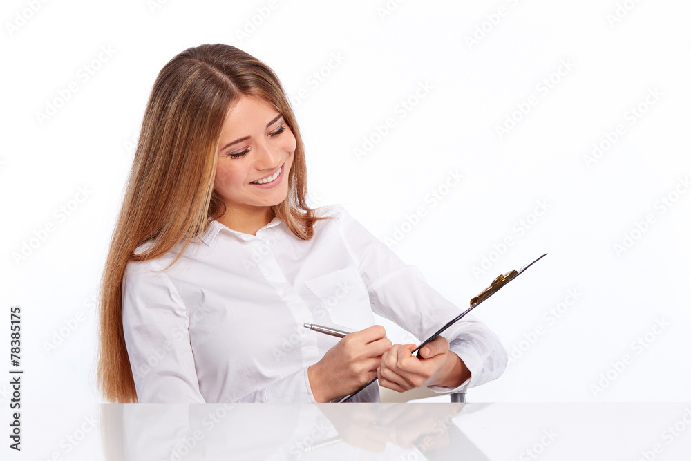 Business young woman writes on the folder Business young woman writes on the folder