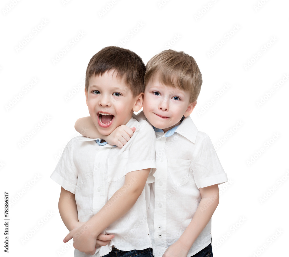 Four-year-old twins boys, one embraces another, isolated Four-year-old twins boys, one embraces another, isolated